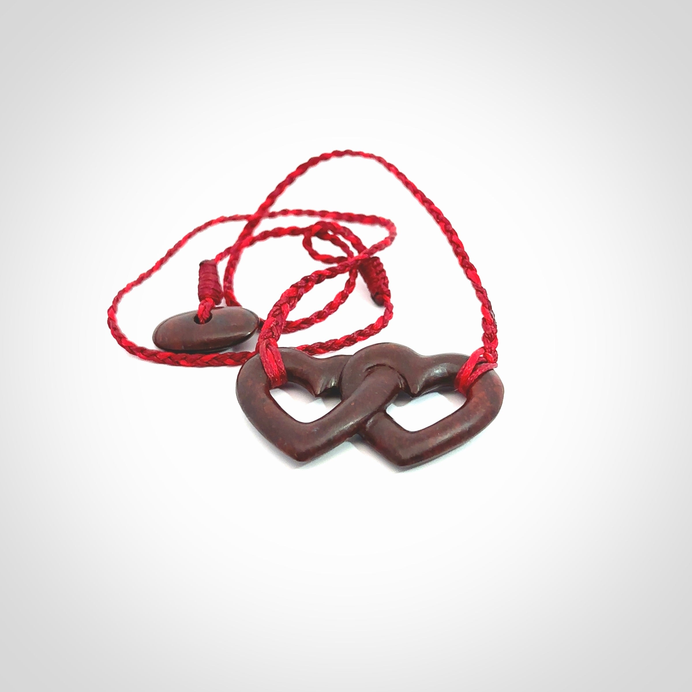 Hand carved double heart pendant made in Red jasper stone. Made by NZ Pacific. Carved from red jasper stone. Free delivery worldwide.