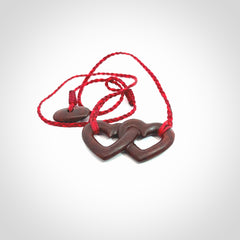 Hand carved double heart pendant made in Red jasper stone. Made by NZ Pacific. Carved from red jasper stone. Free delivery worldwide.