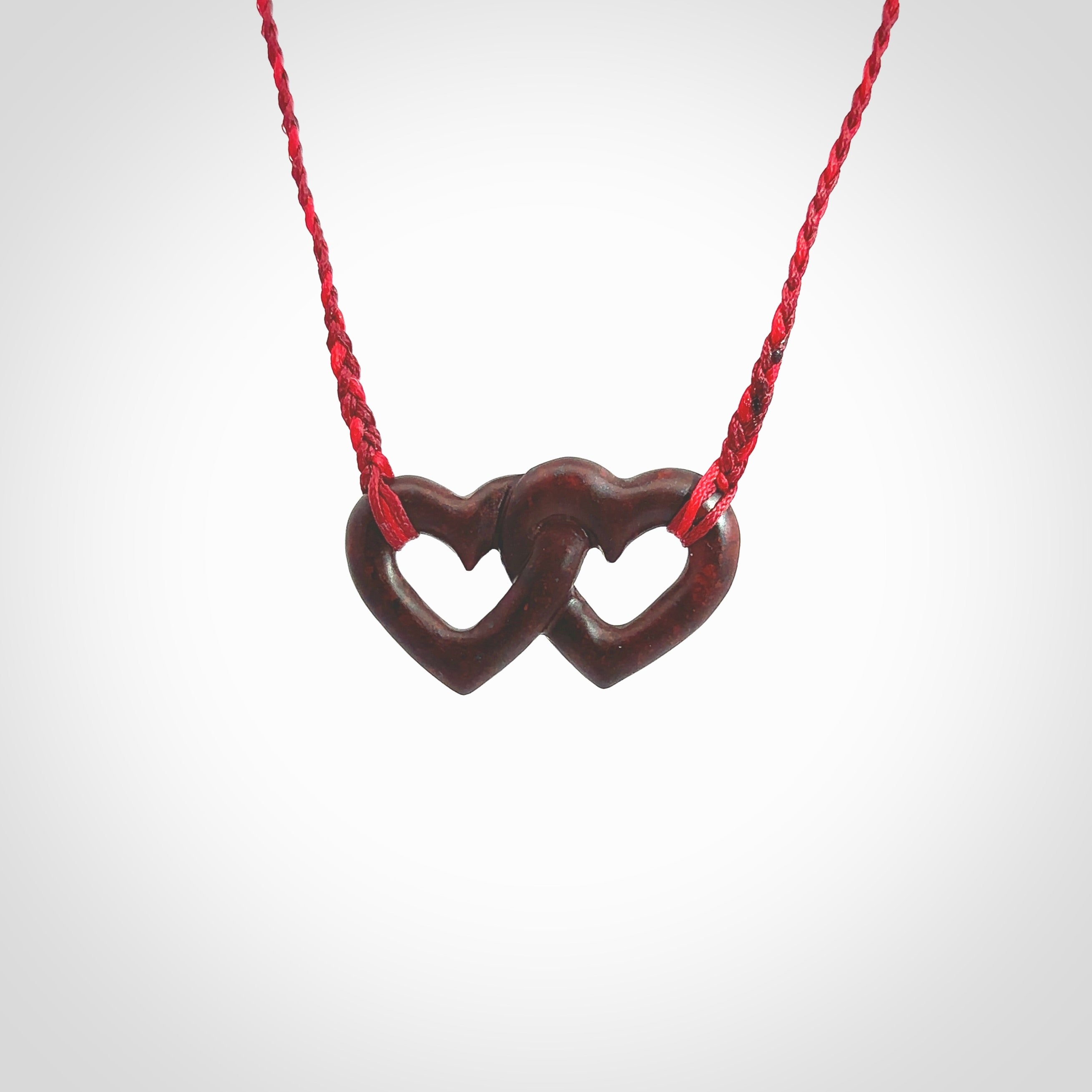 Hand carved double heart pendant made in Red jasper stone. Made by NZ Pacific. Carved from red jasper stone. Free delivery worldwide.