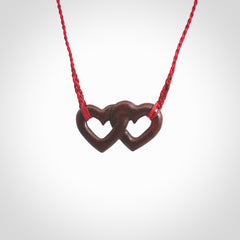 Hand carved double heart pendant made in Red jasper stone. Made by NZ Pacific. Carved from red jasper stone. Free delivery worldwide.