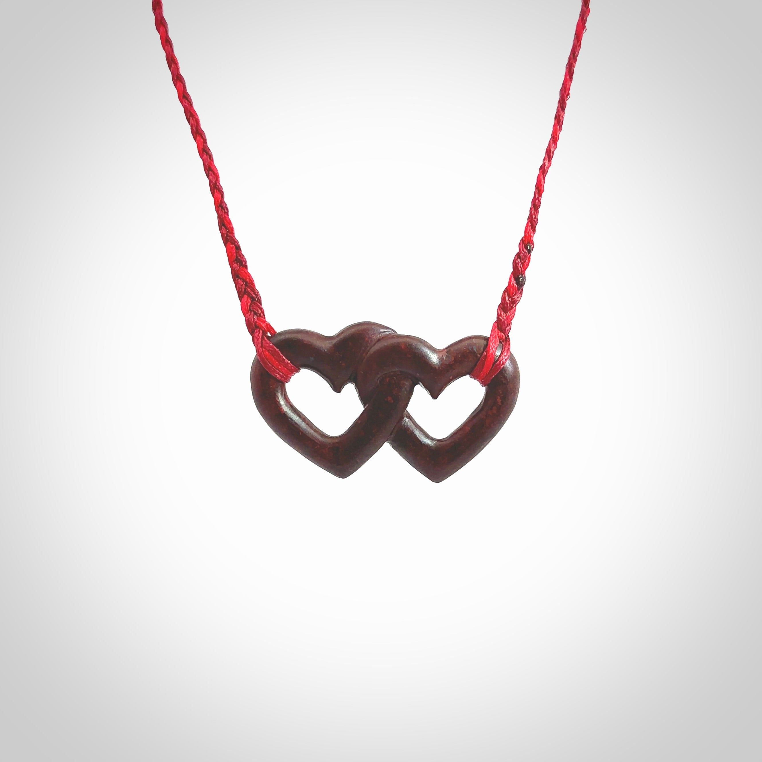 Hand carved double heart pendant made in Red jasper stone. Made by NZ Pacific. Carved from red jasper stone. Free delivery worldwide.