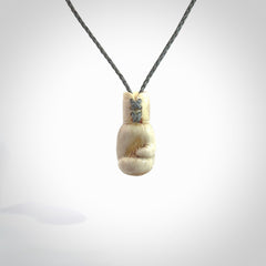 Hand carved boxing glove made from deer antler. The cord is adjustable so that you can wear this where it suits you best.