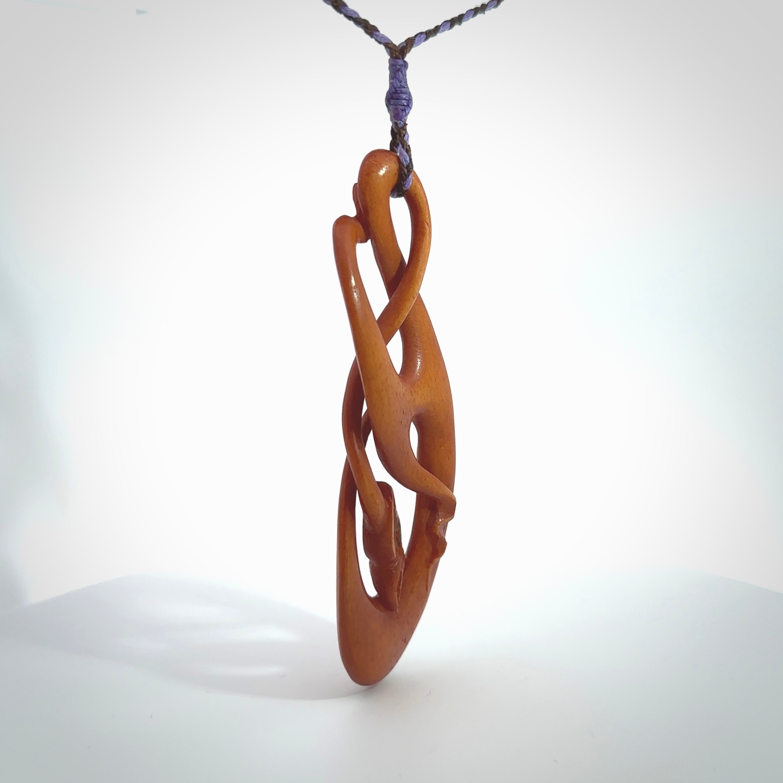 This necklace is carved from cow bone and stained with a homemade tea dye. It is a unique piece of wearable art that is sure to catch the eye. The shape is a complex twist form and has been beautifully hand carved by bone carver Yuri Terenyi.