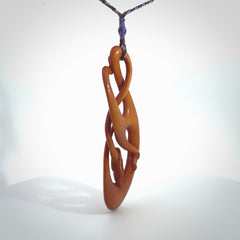 This necklace is carved from cow bone and stained with a homemade tea dye. It is a unique piece of wearable art that is sure to catch the eye. The shape is a complex twist form and has been beautifully hand carved by bone carver Yuri Terenyi.