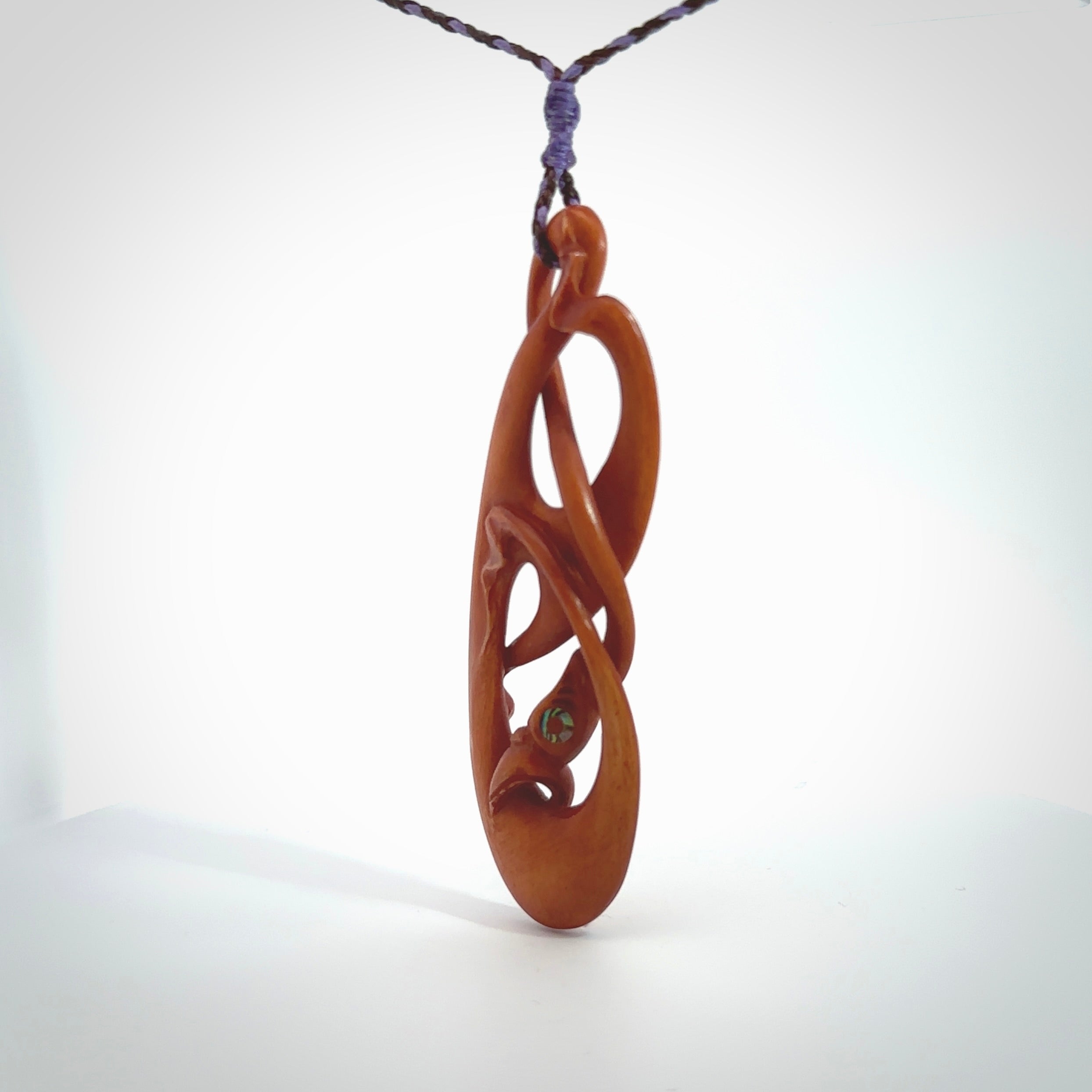 This necklace is carved from cow bone and stained with a homemade tea dye. It is a unique piece of wearable art that is sure to catch the eye. The shape is a complex twist form and has been beautifully hand carved by bone carver Yuri Terenyi.