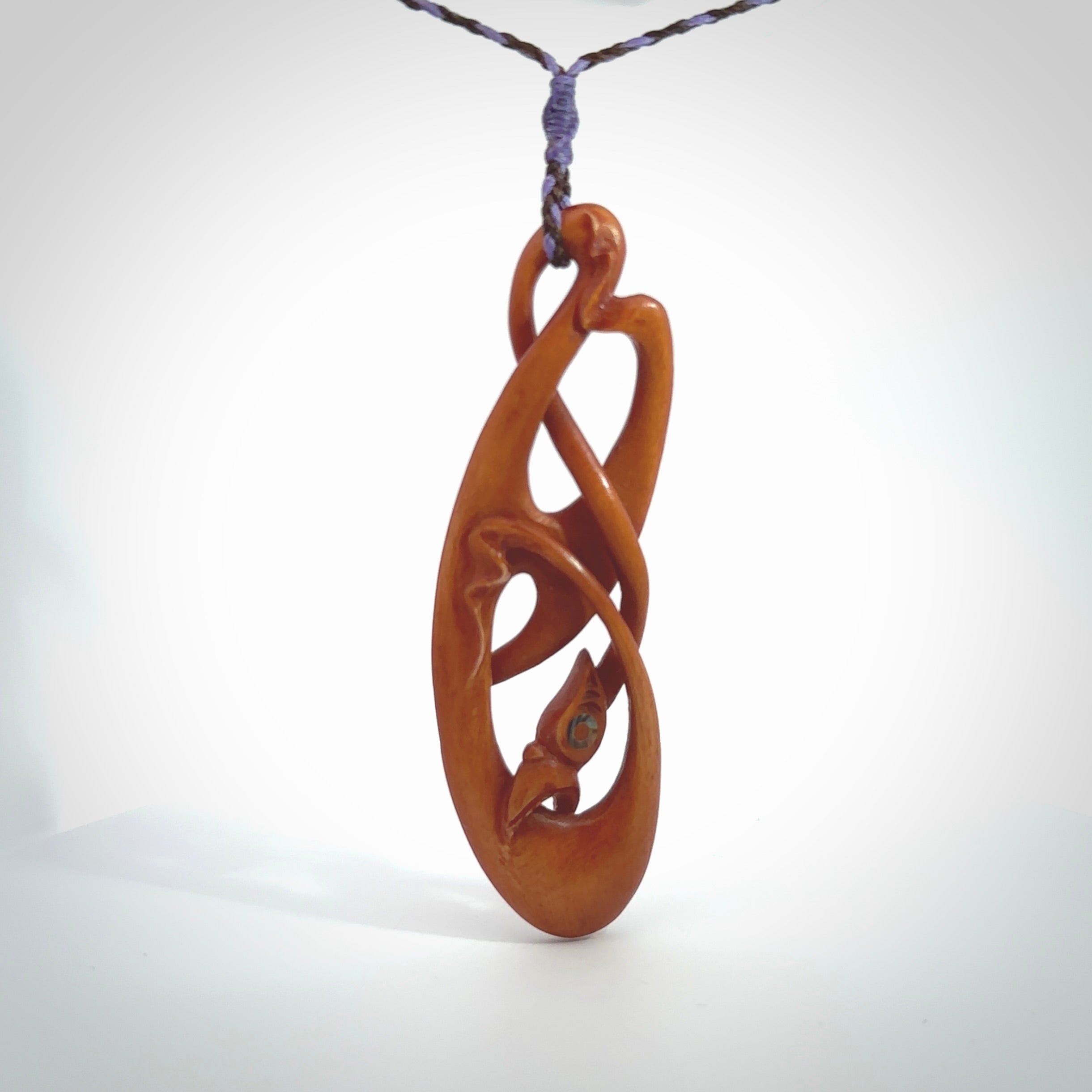 This necklace is carved from cow bone and stained with a homemade tea dye. It is a unique piece of wearable art that is sure to catch the eye. The shape is a complex twist form and has been beautifully hand carved by bone carver Yuri Terenyi.