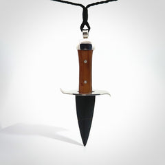 A striking hand carved knife pendant that we've called the blade. These are carved with a jade head and a hardwood handle. The cords are hand plaited in our waxed polyester which is robust, strong and durable. We ship these worldwide with express courier.