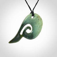 This photo shows a koru pendant carved from New Zealand Jade. The artist, Shaun Gardiner, has carved this beautifully. We provide this piece with an adjustable Black cord. This is a fantastic work of art, we have one only.