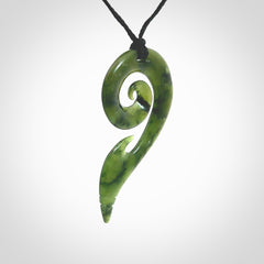 This photo shows a koru pendant carved from New Zealand Jade. The artist, Shaun Gardiner, has carved this beautifully. We provide this piece with an adjustable Black cord. This is a fantastic work of art, we have one only.