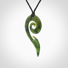 This photo shows a koru pendant carved from New Zealand Jade. The artist, Shaun Gardiner, has carved this beautifully. We provide this piece with an adjustable Black cord. This is a fantastic work of art, we have one only.
