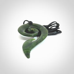 This photo shows a koru pendant carved from New Zealand Jade. The artist, Shaun Gardiner, has carved this beautifully. We provide this piece with an adjustable Black cord. This is a fantastic work of art, we have one only.