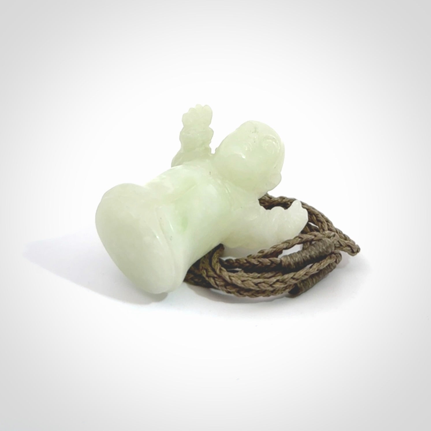 Jadeite monk pendant with adjustable necklace cord. Hand carved by NZ Pacific. Handmade jewellery for sale online. The cord is a hand plaited khaki green colour, which is length adjustable. Peaceful man necklace for men and women. Contemporary necklace hand made from Jadeite.