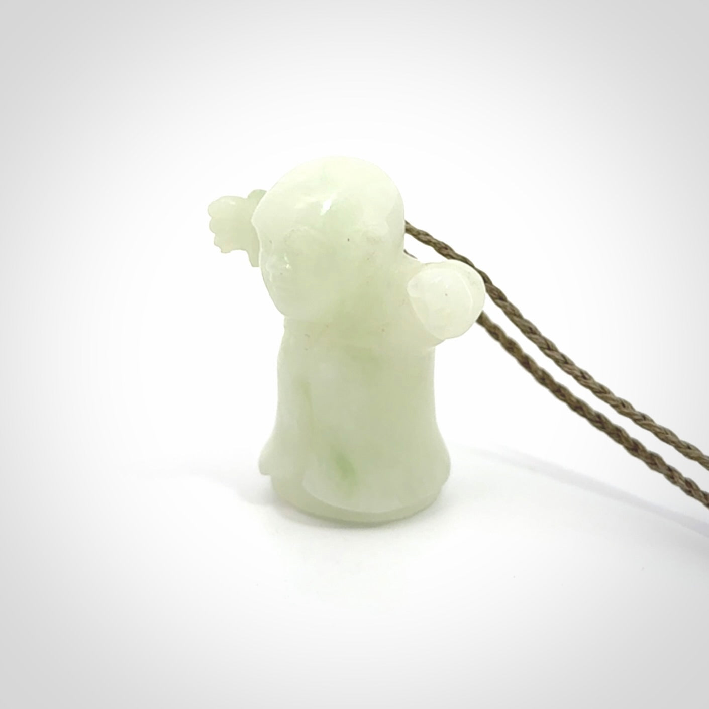 Jadeite monk pendant with adjustable necklace cord. Hand carved by NZ Pacific. Handmade jewellery for sale online. The cord is a hand plaited khaki green colour, which is length adjustable. Peaceful man necklace for men and women. Contemporary necklace hand made from Jadeite.