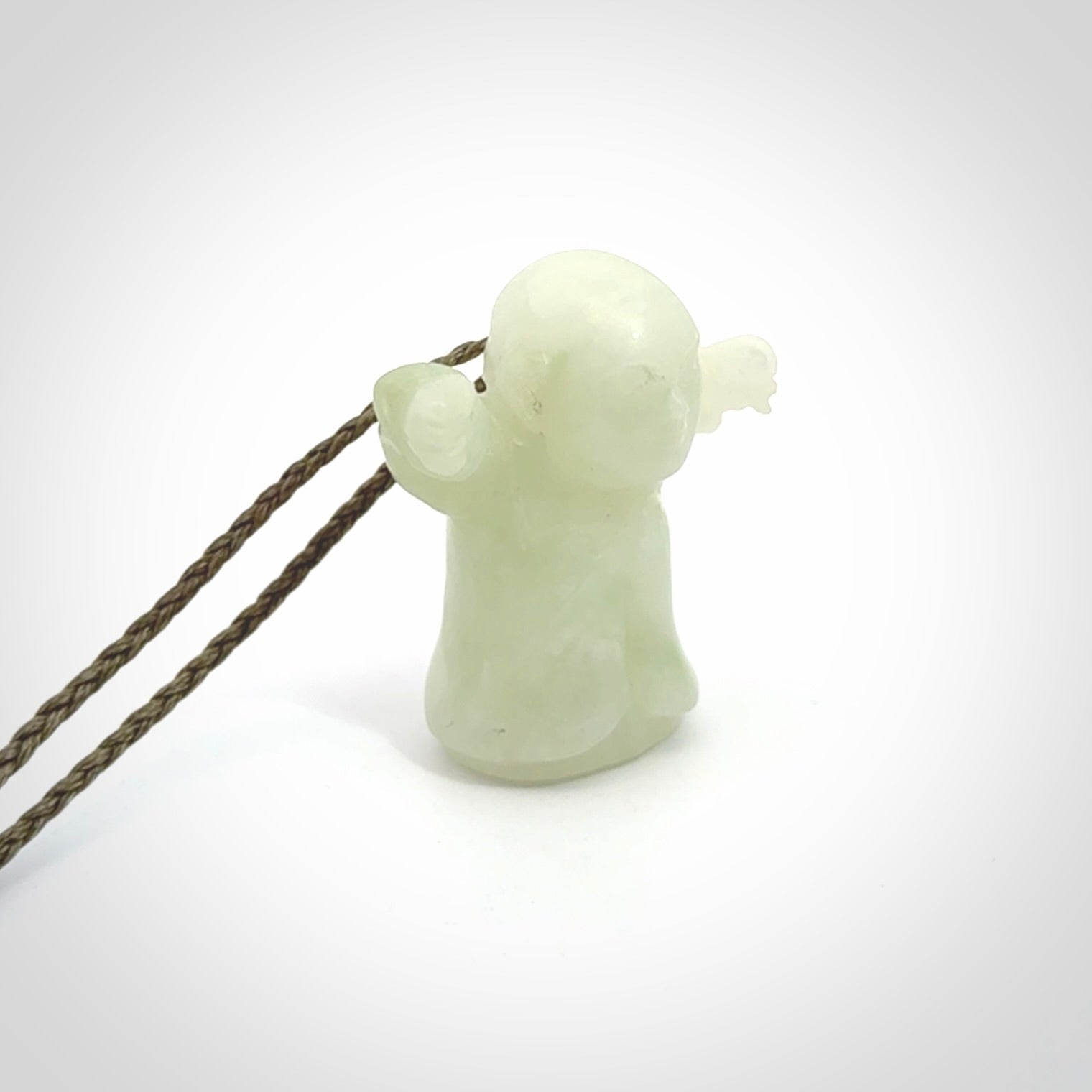 Jadeite monk pendant with adjustable necklace cord. Hand carved by NZ Pacific. Handmade jewellery for sale online. The cord is a hand plaited khaki green colour, which is length adjustable. Peaceful man necklace for men and women. Contemporary necklace hand made from Jadeite.