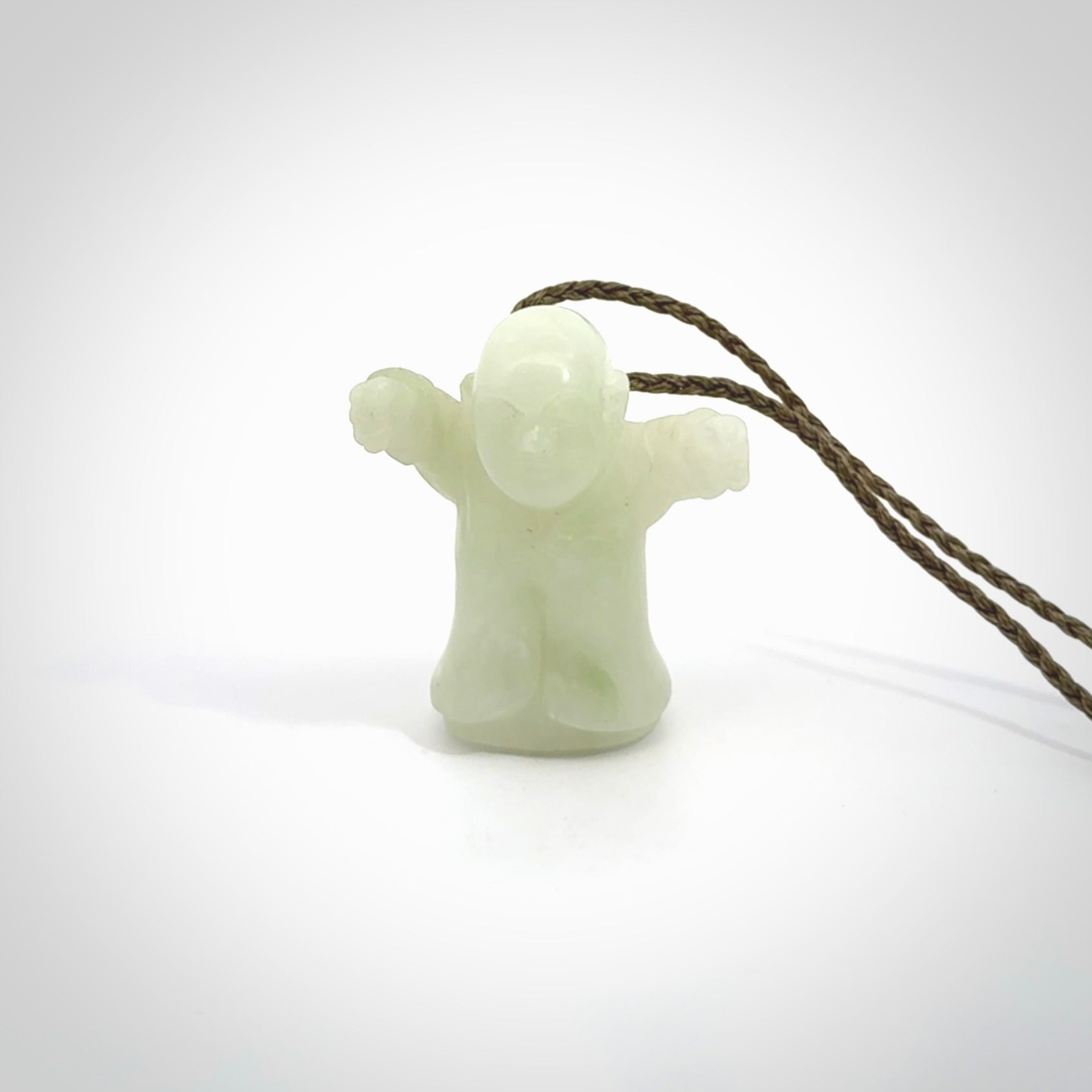 Jadeite monk pendant with adjustable necklace cord. Hand carved by NZ Pacific. Handmade jewellery for sale online. The cord is a hand plaited khaki green colour, which is length adjustable. Peaceful man necklace for men and women. Contemporary necklace hand made from Jadeite.
