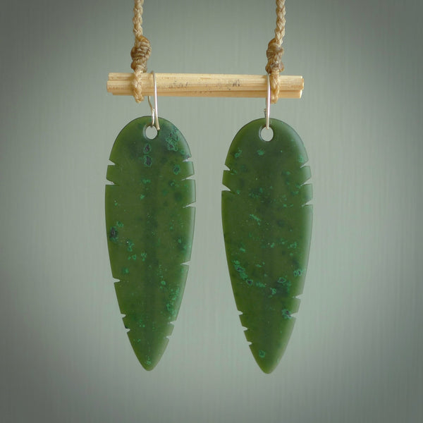 This picture shows British Columbian jade kaka feather earrings with sterling silver hooks. Hand made unique and contemporary feather earrings by Kerry Thompson. Hand carved here in New Zealand from British Columbian Jade. One pair only.