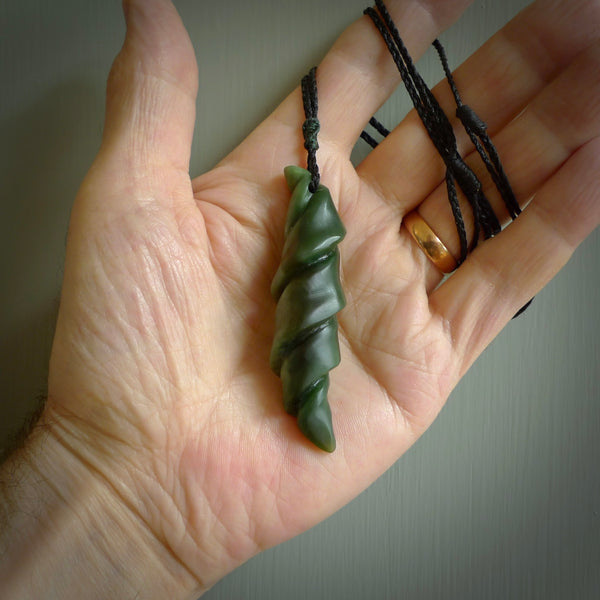 This is a unique complex twisted drop pendant, hand carved from New Zealand Jade. The cord is black and is length adjustable. This is delivered to you with Express Courier. Hand carved Pounamu, Jade necklace with adjustable cord from Ana Krakosky.