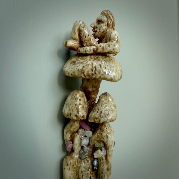 This picture shows a carved tripping man on mushroom heru, comb in whale bone with Rubies and Sapphires. The materials are a blend of whale bone, raw rubies and sapphires. Free shipping worldwide. One only collectable art to wear.