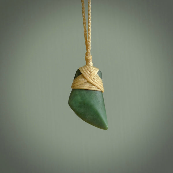 Hand carved jade toki by Ric Moor. Made in New Zealand by NZ Pacific. Hand carved Toki pendants crafted from beautiful New Zealand Pounamu, Jade. We deliver these with Express Courier, on adjustable cords.