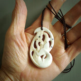 Bone carving of a taniwha. A three dimensional pendant carved in bone by Andrew Doughty. One only taniwha carving for men and women. Provided with an adjustable cord.