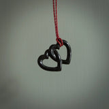 Hand carved double heart pendant made in black jade, green jade and jasper stone. Made by NZ Pacific. Carved from green jade, black jade and red jasper stone. Free delivery worldwide.