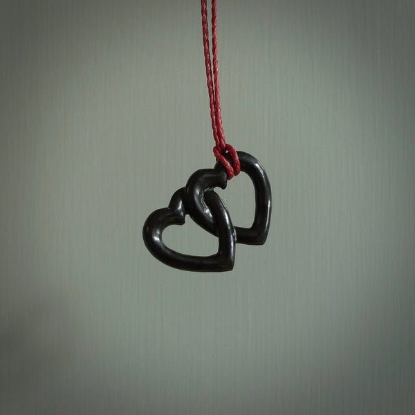 Hand carved double heart pendant made in black jade, green jade and jasper stone. Made by NZ Pacific. Carved from green jade, black jade and red jasper stone. Free delivery worldwide.
