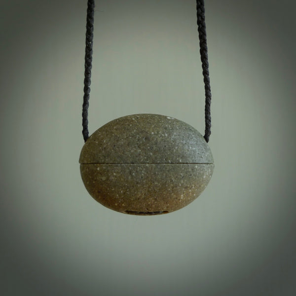 Greywacke stone pendant with Black Pearl insert. Hand carved by Rhys Hall for NZ Pacific. Handmade contemporary jewellery for sale online.