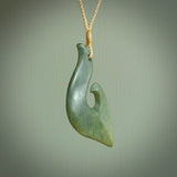 This matau, is a large pendant hand carved from New Zealand jade. It is both intricate and contemporary in design - it has hidden folds and smooth curves. A piece to be worn, the carving and the jade are both magnificent. A large hand carved New Zealand Jade hook by artist Ric Moor.