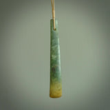 This is a lovely, large, New Zealand Flower Jade, pounamu drop pendant. Hand carved for us by Ric Moor. It is bound with an adjustable beige coloured cord which is length adjustable. Free worldwide shipping. The light reveals the internal structure and colour of the stone beautifully.