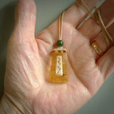 This pendant is handcrafted from rare Kauri Gum Amber with Woolly Mammoth Tusk insert. It is supplied with an adjustable tan cord. It is a graceful and very interesting piece that will attract admiration and comment. Hand carved here in New Zealand by Sami.