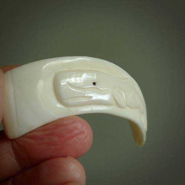 Hand carved whale pendant, carved by us. This piece is carved from boars tusk and is a fantastic depiction of these giants of the deep. This particular piece is a whale design and is lovingly carved.