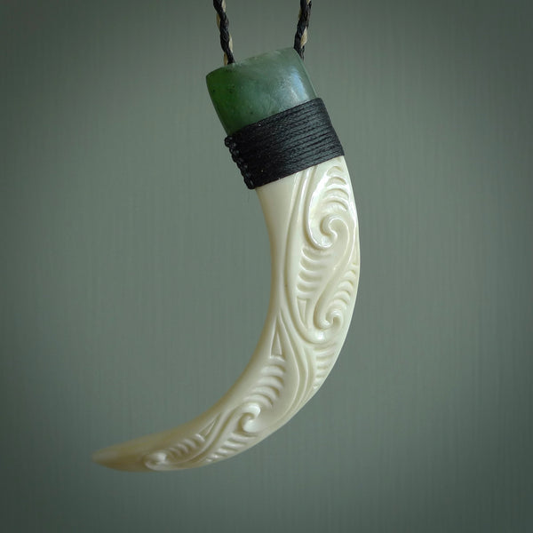 Boars Tusk Pendant with a jade cap. Hand made pendant carved from a boars tusk. Hand made ethnic or maori jewellery for sale by NZ Pacific online.