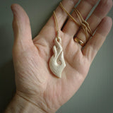 Hand carved stellar intricate twist carving with hook design. A stunning work of art. This pendant was hand carved by Fumio Noguchi, in Bone. A one off collectors item that has been hand crafted to be worn or displayed.