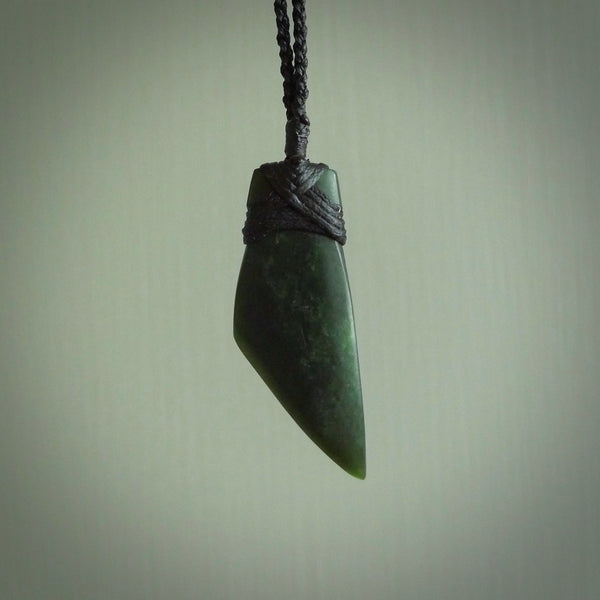 Hand carved from a lovely piece of local New Zealand Jade. The quality of the workmanship and design is outstanding - this is a piece you will want to wear all the time. We have suspended this from a 3-plait black cord which can be adjusted with a couple of slip knots and black binding.