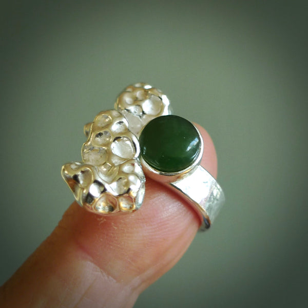 This is a handcrafted New Zealand Pounamu, Jade and sterling silver ring. This is a solid little work of art. We ship this worldwide for free and are happy to answer any questions that you may have about these or other products on our website.