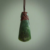 Hand carved from a lovely piece of local New Zealand Jade. The quality of the workmanship and design is outstanding - this is a piece you will want to wear all the time. We have suspended this from a 3-plait brown cord which can be adjusted with a couple of slip knots and brown binding.