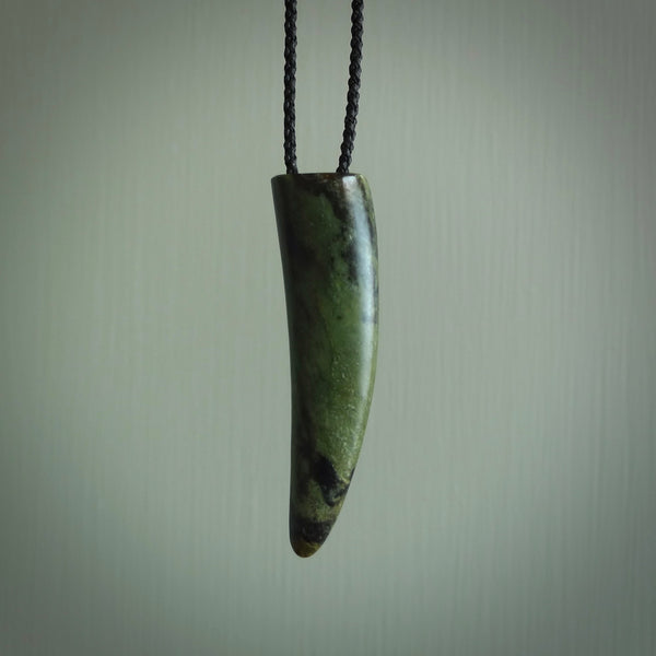 This is a lovely New Zealand Jade, pounamu drop pendant. Hand carved for us by Ric Moor. It is bound with an adjustable black coloured cord which is length adjustable. Free worldwide shipping.