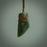 Hand carved from a lovely piece of local New Zealand Jade. The quality of the workmanship and design is outstanding - this is a piece you will want to wear all the time. We have suspended this from a 4-plait olive cord which can be adjusted with a couple of slip knots and olive binding.