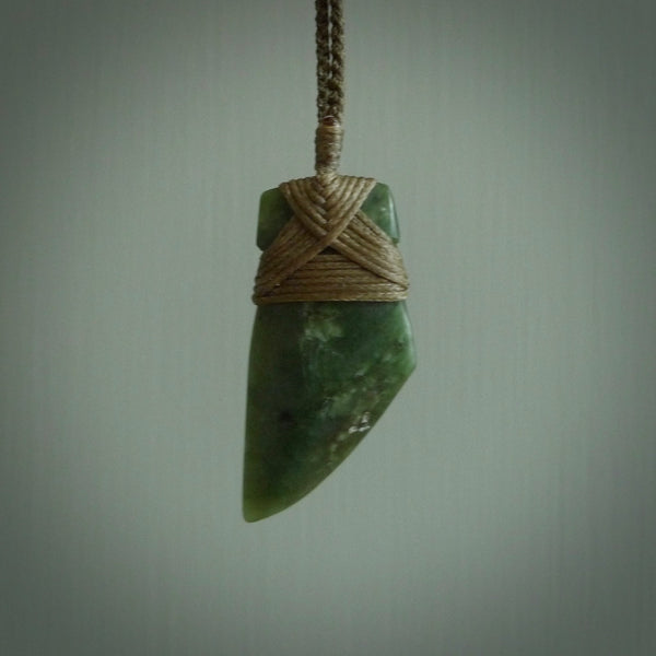 Hand carved from a lovely piece of local New Zealand Jade. The quality of the workmanship and design is outstanding - this is a piece you will want to wear all the time. We have suspended this from a 4-plait olive cord which can be adjusted with a couple of slip knots and olive binding.