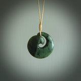 This picture shows a koru pendant, hand carved from New Zealand jade. We will provide this with an adjustable plaited cord. This has been hand carved by Kyohei Noguchi. One only pendant, shipped to you with express courier.