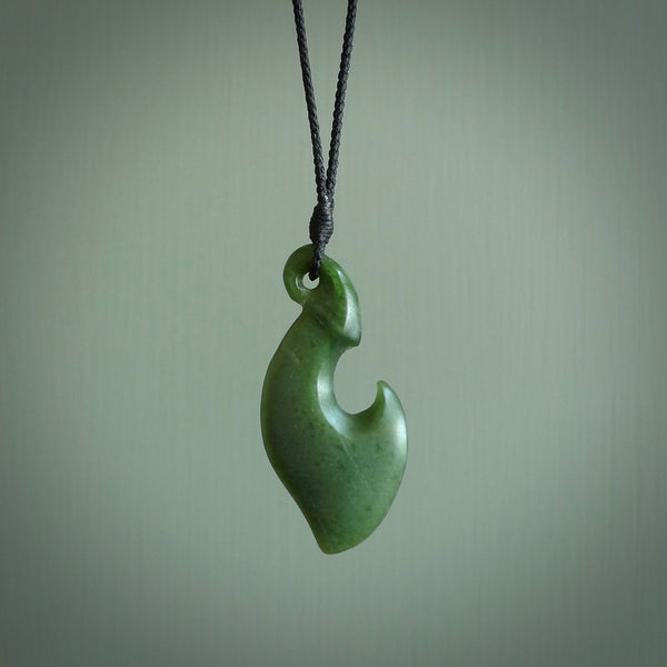 This contemporary hook, is carved from a very striking New Zealand jade. It is both intricate and simple in design - it has hidden folds and smooth curves. A piece to be worn or displayed - the carving and the jade are both magnificent.