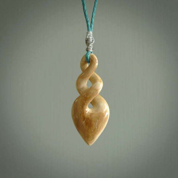 Hand carved woolly mammoth ivory twist pendant. Made by NZ Pacific.