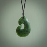 This photo shows a traditional hook pendant. It a a lovely deep green jade. The cord is a four plait black and is adjustable in length. One only, contemporary matau necklace from Jade, by Ric Moor.