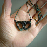 Hand carved double heart pendant made in black jade, green jade and jasper stone. Made by NZ Pacific. Carved from green jade, black jade and red jasper stone. Free delivery worldwide.