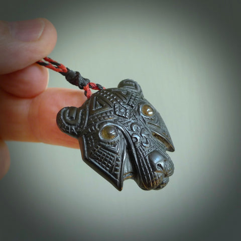 This picture shows a tiger pendant that we designed in black jade. It is a black tiger necklace that is carved in detail. A really attractive and eye-catching piece of handmade jewellery. The cord is hand plaited braid in red and black and the length can be adjusted. Delivered to you in a woven kete pouch and shipped with Express Courier.