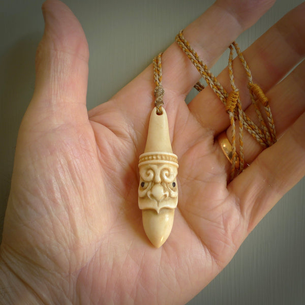 Hand carved incredible stained bone gargoyle face carving. A stunning work of art. This pendant was hand carved in bone with buffalo horn inlay for the eyes by Yuri Terenyi. A one off collectors item that has been hand crafted to be worn or displayed.