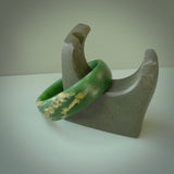 Hand carved jade bangle. Carved from green New Zealand jade. This is a solid jade bangle carved from a single piece of jade. It is polished to a sleek matte. the jade is otherwise untreated and completely natural.