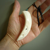 Hand carved engraved boars tusk pendant, carved by us. This particular piece is a contemporary design and is lovingly carved.
