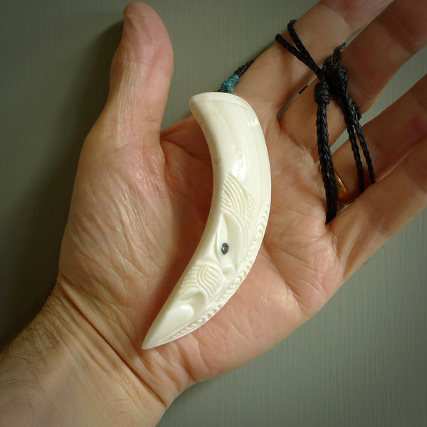 Hand carved engraved boars tusk pendant, carved by us. This particular piece is a contemporary design and is lovingly carved.