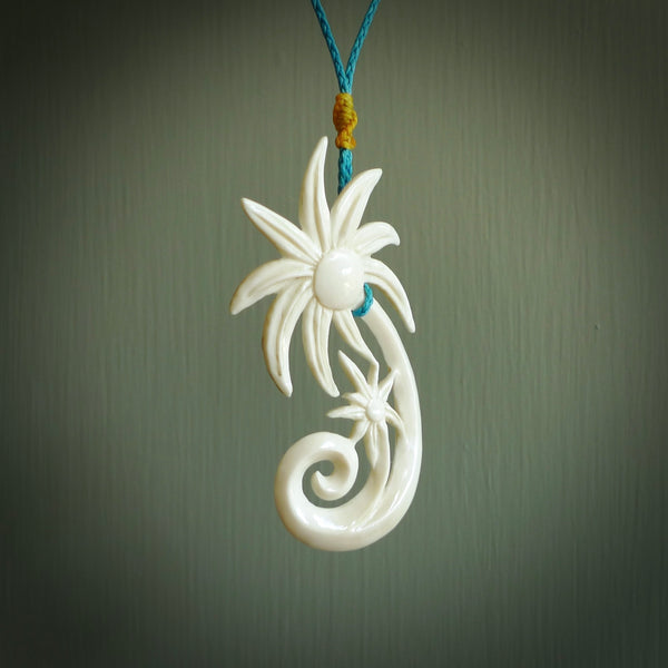 This is a hand carved palm tree pendant. It is made from bone. This is a large sized necklace and is a very unique. Hand carved bone palm tree necklace. Delivered on an adjustable cord.